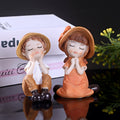 A Set of Two Adorable Mini Decorations Featuring a Boy And a Girl, Including Statues And Doll Sets Made from Resin